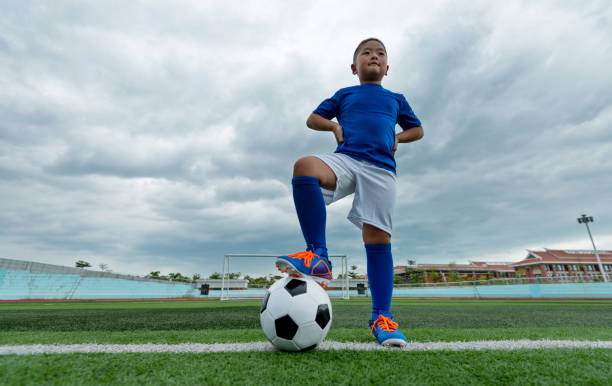 Young football player waiting for kick off